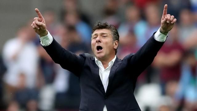 Watford boss Walter Mazzarri offers a drink to old rival Jose Mourinho