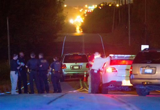 Police work the scene of a shooting late Friday Sept. 16 2016 in Tulsa Okla. A Tulsa police officer shot and killed a black man who ignored repeated requests to put up his hands before reaching into an SUV that was stalled in the middle of a street