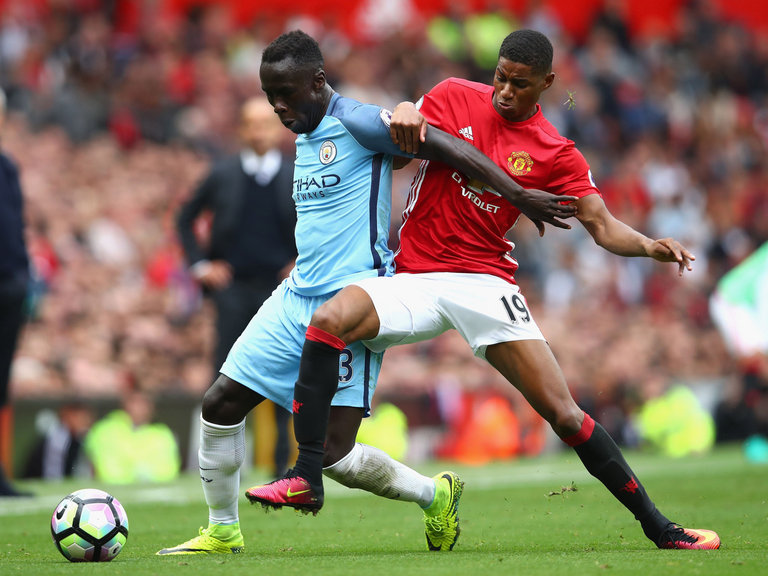 Marcus Rashford challenges Bacary Sagna after coming off the bench during the Manchester derby