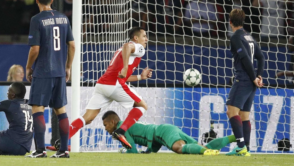 Arsenal's Alexis Sanchez centre scores his side's first goal during the Champions League group A soccer match group between Paris Saint Germain and Arsenal at the Parc des Princes stadium in Paris Tuesday Sept. 13 2016. (AP