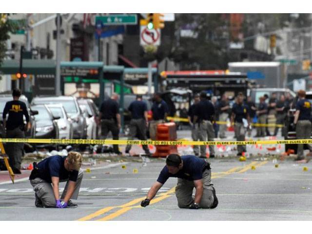 Federal Bureau of Investigation officials mark the ground near the site of an explosion in the Chelsea neighborhood of Manhattan New York US