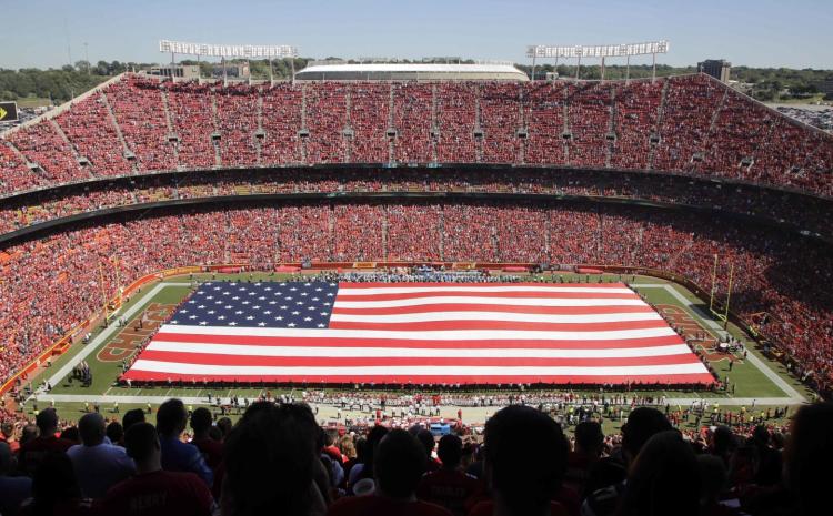 A giant flag is spread over the field at Arrowhead Stadium to commemorate Sept. 11 before the game between the Kansas City Chiefs and the San Diego Chargers