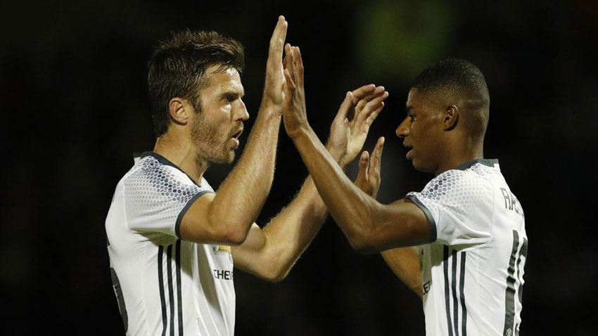 Marcus Rashford celebrates his goal with Michael Carrick in their English League clash with Northampton