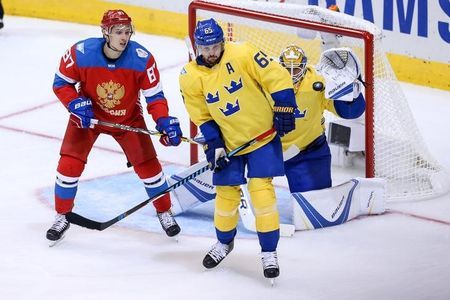 Nikita Kucherov right takes a shot at goalie Jacob Markstrom while being defended by Anton Stralman during Russia's 2-1 loss to Sweden on Sunday in Toronto