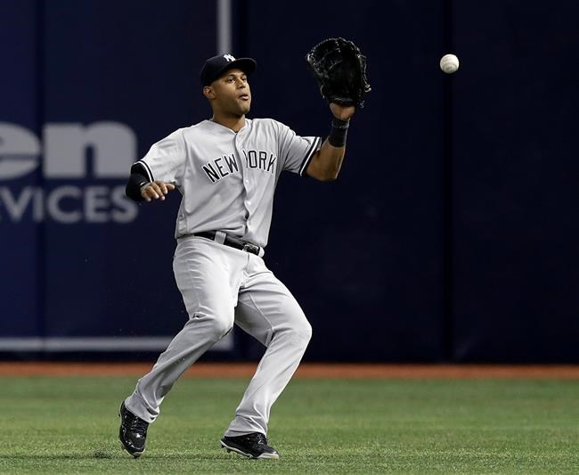 New York Yankees right fielder Aaron Hicks has a single by Tampa Bay Rays&#39 Logan Forsythe bounce away from him during the first inning of a baseball game Thursday Sept. 22 2016 in St. Petersburg Fla. The Rays won the game 2-0. (AP