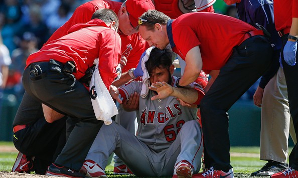 SEATTLE WA- SEPTEMBER 04 Starting pitcher Matt Shoemaker #52 of the Los Angeles Angels of Anaheim is helped off the field after being hit in the head with a batted ball off the bat of Kyle Seager of the Seattle Mariners in the second inning at Safeco