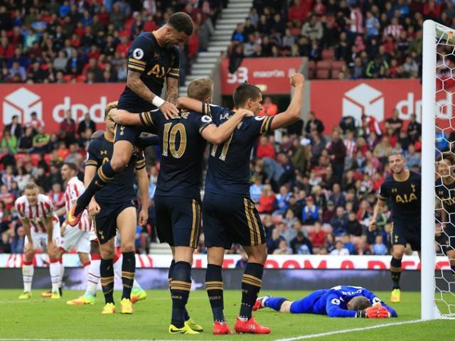 Tottenham Hotspur's English striker Harry Kane is mobbed by teammates after scoring his team's fourth goal during the English Premier League football match between Stoke City and Tottenham Hotspur at the Bet365 Stadium in Stoke-on-Trent cen