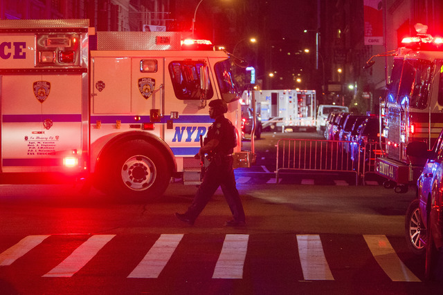 ASSOCIATED PRESS           Heavily armed police guard the area as they search for an explosive device on West 27th Street and 7th Avenue in Manhattan’s Chelsea neighborhood