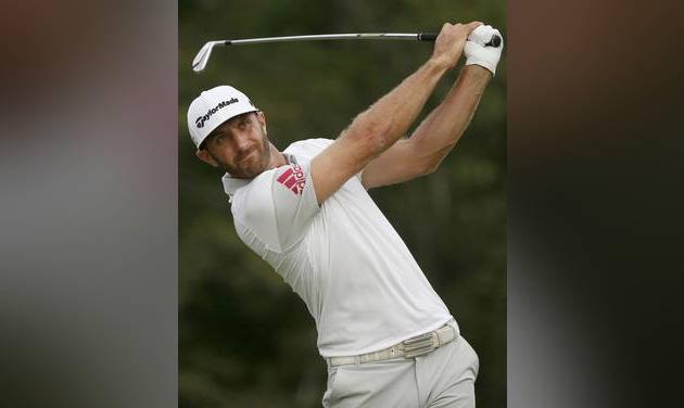 Dustin Johnson watches his tee shot on the 17th hole during the second round of the Deutsche Bank Championship golf tournament in Norton Mass. Dustin Johnson has his own gold medal. It's actually a coin