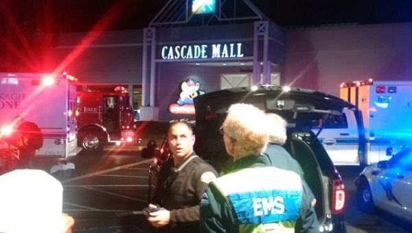 Medics wait to gain access to the Cascade Mall after four people were shot dead in Burlington Washington