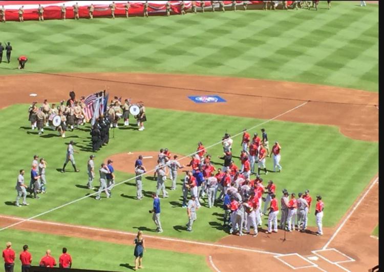 Members of the Mets and Braves gather in the infield to shake hands before Sunday's game