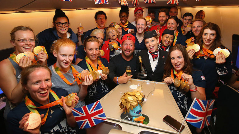 Members of the Paralympics GB Team show their medals on flight back home