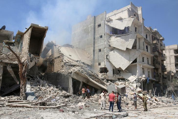 Men inspect a damaged site after double airstrikes on the rebel held Bab al Nairab neighborhood of Aleppo Syria