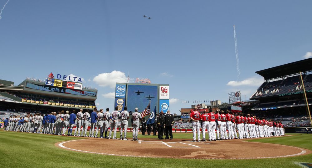 The Atlanta Braves and the New York Mets participate in a 9/11 commemoration as jets pass overhead before a baseball game in Atlanta Sunday Sept. 11 2016