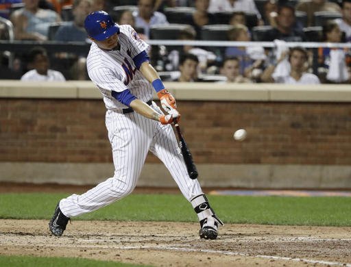 New York Mets Wilmer Flores hits a grand slam during the fifth inning of a baseball game against the Philadelphia Phillies on Friday Aug. 26 2016 in New York