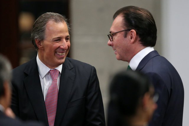 Mexico's new Finance Minister Jose Antonio Meade smiles next to former Finance Minister Luis Videgaray during the announcement of new cabinet members at Los Pinos presidential residence in Mexico City Mexico