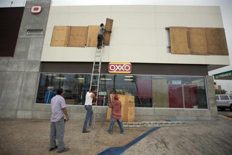 Workers board over a store front in preparation for Hurricane Newton in Cabo San Lucas Mexico Monday Sept. 5 2016. Authorities at the southern end of Mexico's Baja California peninsula ordered schools closed and set up emergency shelters as Hurri