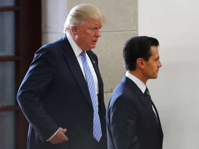 Donald Trump left walks behind Mexico's President Enrique Pena Nieto as they arrive to deliver statements to the press in Mexico City Wednesday. Associated Press