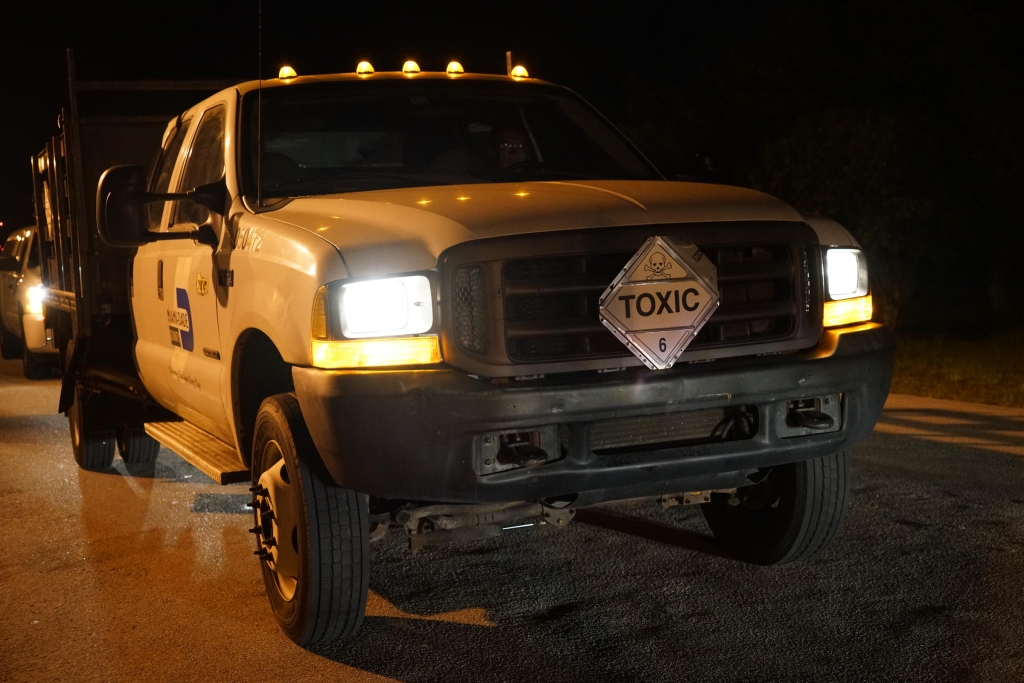 Miami-Dade County trucks transportind the insecticide to be used in aerial spraying over Miami Beach