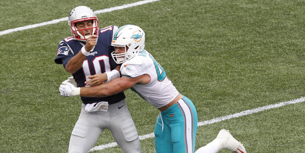 Miami Dolphins linebacker Kiko Alonso right hits New England Patriots quarterback Jimmy Garoppolo