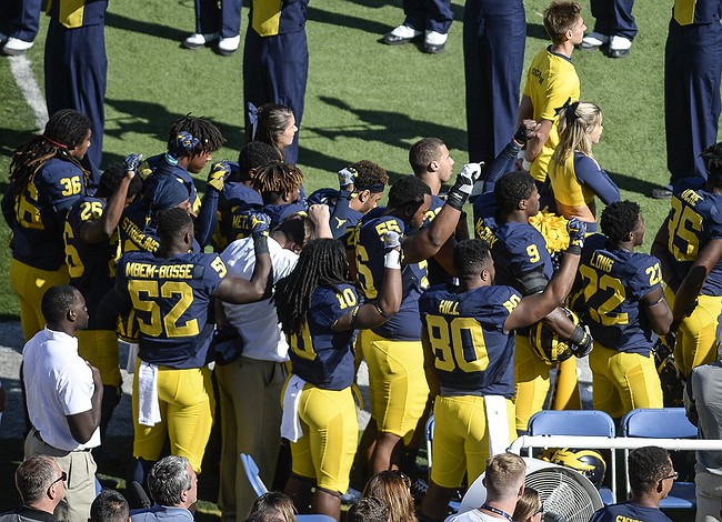 Michigan State players raise fists during national anthem