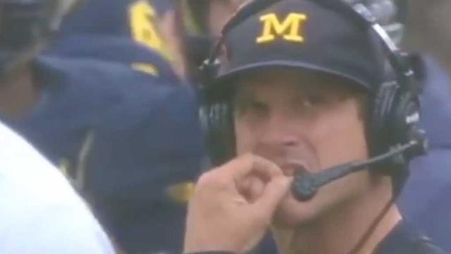 American college coach denies picking his nose and eating