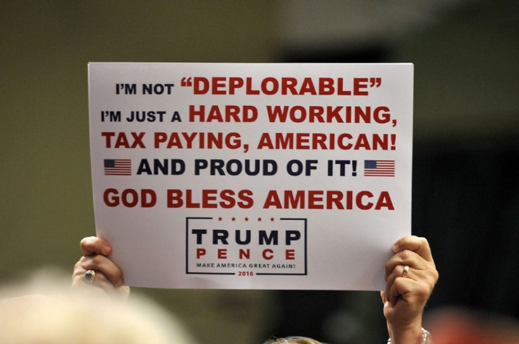 A supporter of Republican Presidential nominee Donald Trump holds a sign at a campaign rally on Tuesday in Clive Iowa. The sign is a direct response to Hillary Clinton's assertion last week that'half of Trump's supporters are a'basket of dep