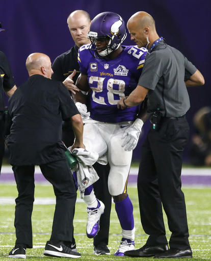 Minnesota Vikings running back Adrian Peterson is helped off the field after getting injured during the second half of an NFL football game against the Green Bay Packers Sunday Sept. 18 2016 in Minneapolis