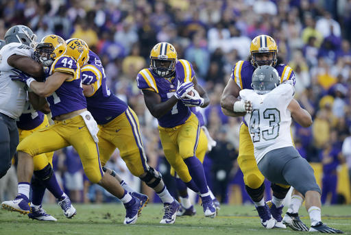 LSU running back Leonard Fournette carries past Eastern Michigan linebacker Anthony Zappone in the first half of an NCAA college football game in Baton Rouge La. Wiscon