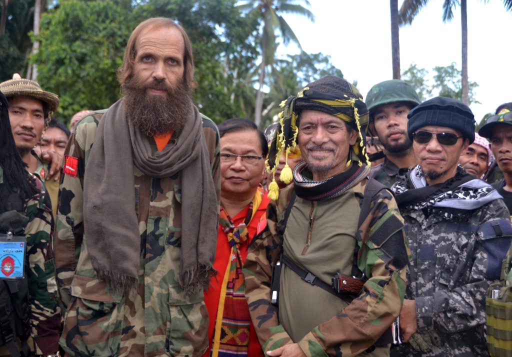 Released Norwegian hostage Kjartan Sekkingstad front row left poses with Moro National Liberation Front Chairman Nur Misuari front row second right after being turned over by ransom-seeking Abu Sayyaf extremists in Indanan township on Jolo island in