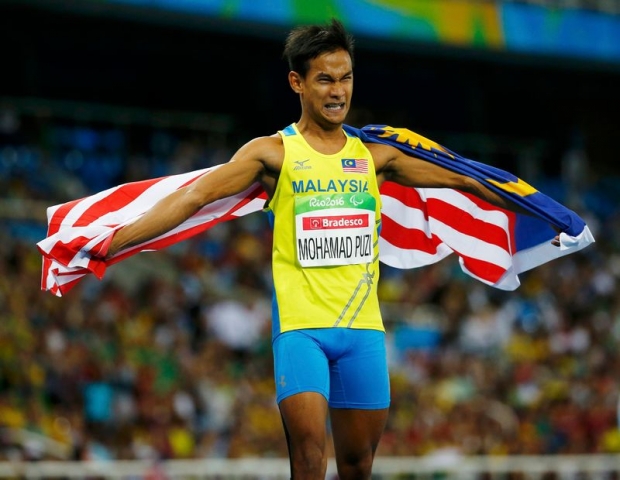 Mohamad Ridzuan Mohamad Puzi of Malaysia celebrates after winning the Rio Paralympics gold medal in the men's 100m in Rio de Janeiro