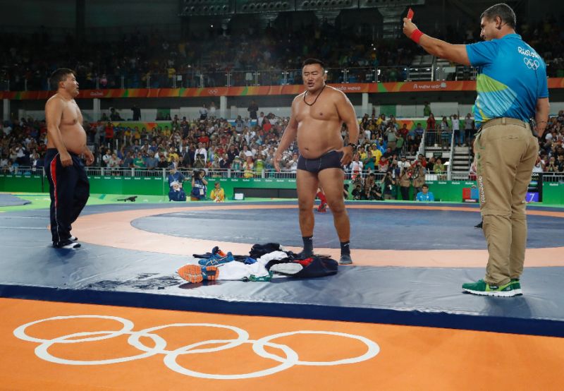 Mongolia's Mandakhnaran Ganzorig's coaches react after the judges announced that Uzbekistan's Ikhtiyor Navruzov won during the wrestling event of the Rio 2016 Olympic Games