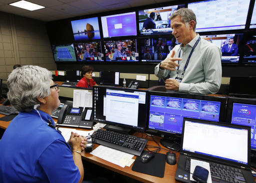 U.S. Open Tennis Tournament Security Director Michael Rodriguez talks with a worker at the tournament's command center inside the Billie Jean King National Tennis Center in New York. With more than 700,000 fans exp