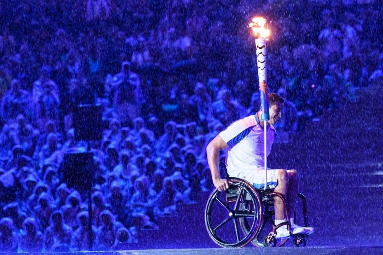 Brazilian swimmer Clodoaldo Silva holds the Paralympic torch to light the Paralympic cauldron during the opening ceremony of the Rio 2016 Paralympic Games at the Maracana stadium in Rio de Janeiro