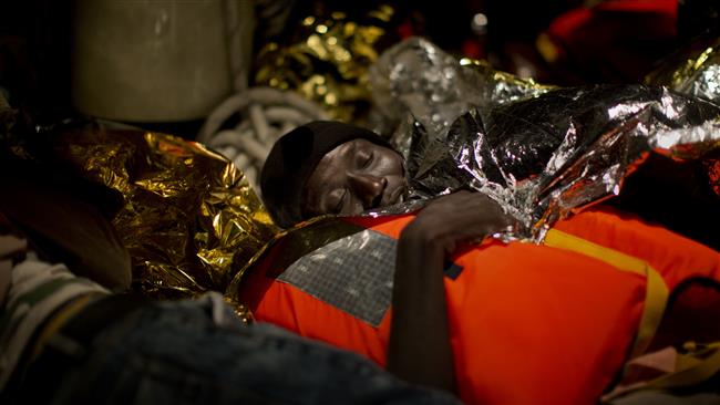 A refugee from Eritrea sleeps on a vessel after being rescued from the Mediterranean sea about 13 miles north of Sabratha Libya