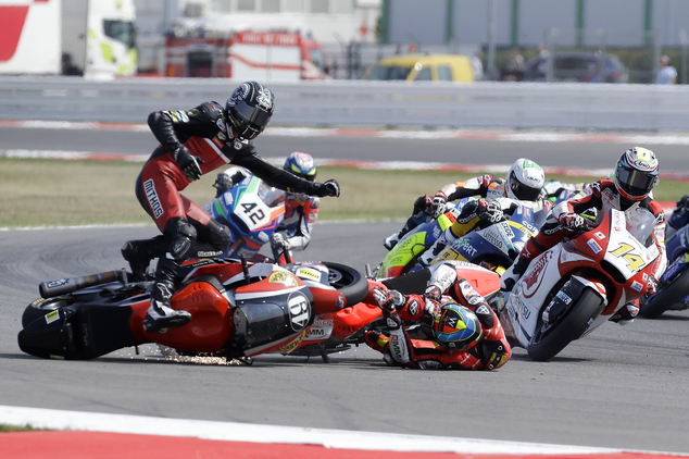 Axel Pons left and Xavier Simeon center on the ground crash on the opening lap of the San Marino Moto2 grand prix at the Misano circuit in Misano Adriat