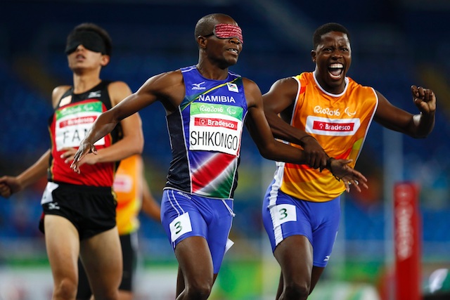 Ananias Shikongo of Namibia celebrates with his guide Even Tjiviju after winning the gold medal in the event. Reuters