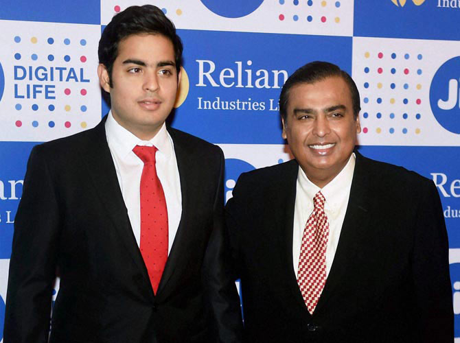 Mukesh Ambani Chairman Reliance Industries Ltd. with his son Akash Ambani at the company's annual general meeting in Mumbai on Thursday. Pic  PTI