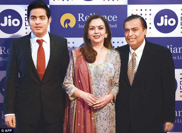 Mukesh Ambani with his wife Nita and son Akash on their arrival for the company's annual general meeting in Mumbai