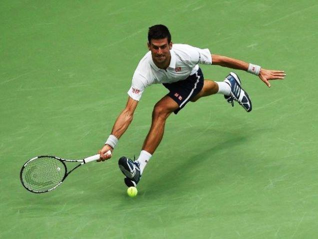 Serbia's Novak Djokovic hits a return to France's Gael Monfils during their 2016 US Open men's singles semifinals match at the USTA Billie Jean King National Tennis Centre in New York on Friday