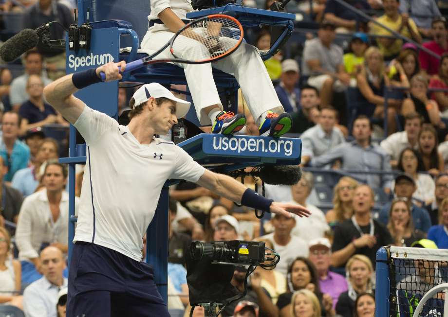 Andy Murray smashes his racket on the net while losing against Kei Nishikori during their U.S. Open quarterfinals match in New York. Nishikori advanced to the semifinals