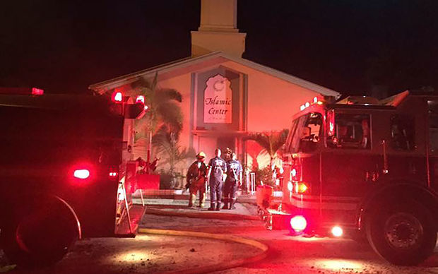 In this image obtained from the St. Lucie County Sheriff's Office firefighters put out a blaze at the Islamic Center of Fort Pierce in Florida on 12 September