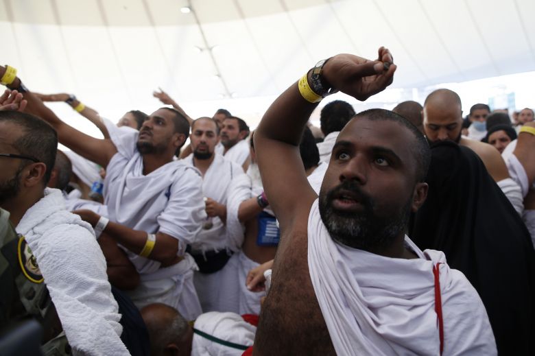 Muslim pilgrims throw pebbles at pillars during the'Jamarat ritual the stoning of Satan in Mina near the holy city of Mecca