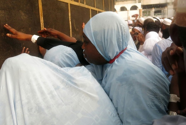 Muslim pilgrims touch the Kaaba Islam's holiest shrine at the Grand Mosque in Saudi Arabia's holy city of Mecca