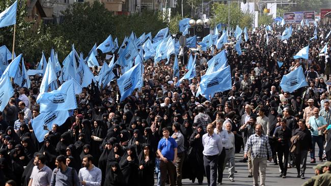 Iranian mourners take part in a funeral procession for some of the Iranian pilgrims who were killed in a stampede at the annual Hajj crush in Tehran