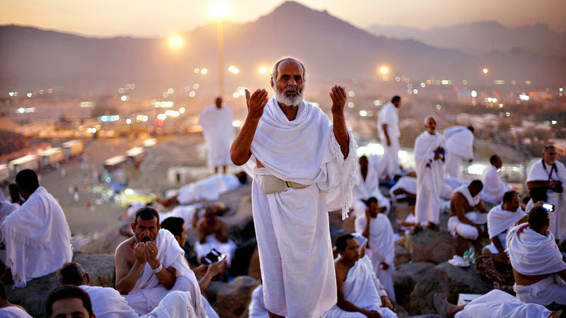 Muslim pilgrim walks through the site where dead bodies are gathered after a stampede during the annual hajj pilgrimage in Mina Saudi Arabia