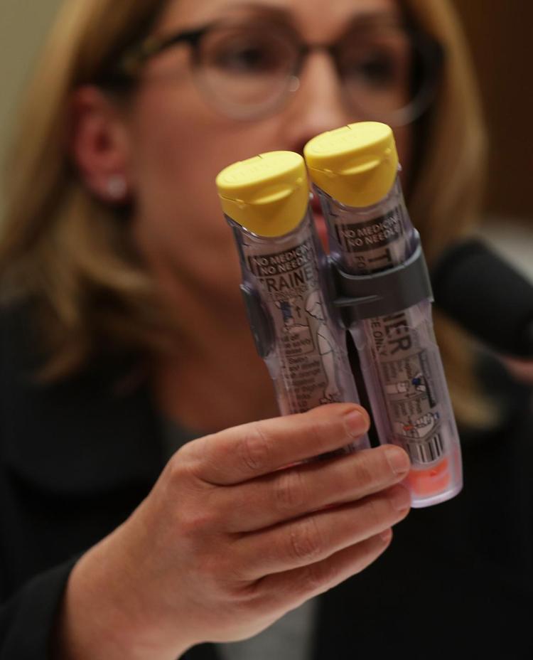 Mylan Inc. CEO Heather Bresch holds up a 2-pack of Epi Pen as she testifies during a hearing before the House Oversight and Government Reform Committee on Capitol Hill