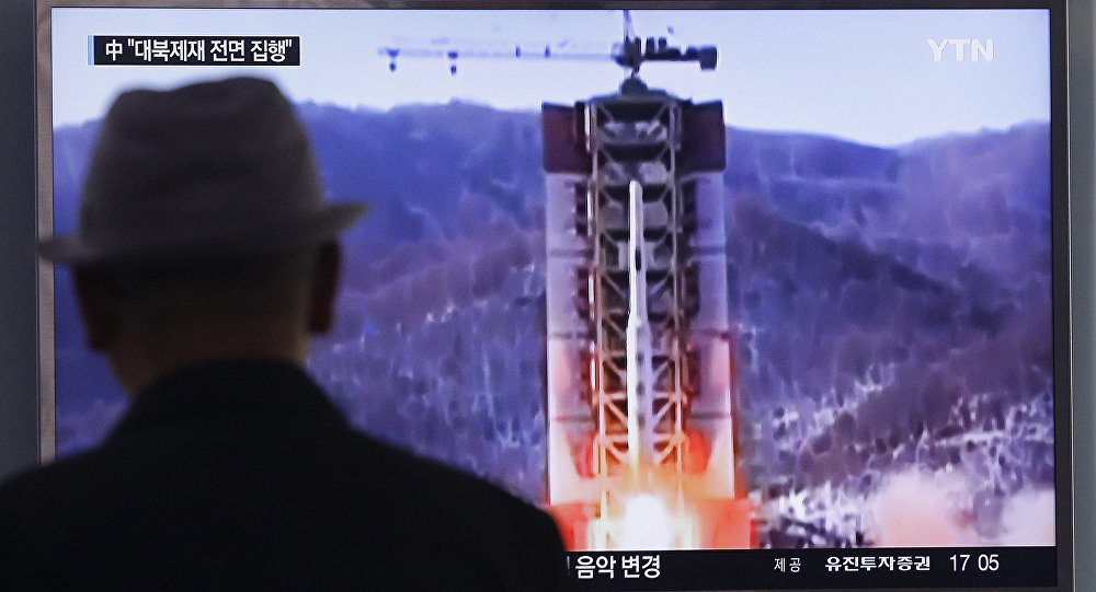 A man watches a TV news program showing a file footage of North Korea's rocket launch at Seoul Railway Station in Seoul South Korea Thursday