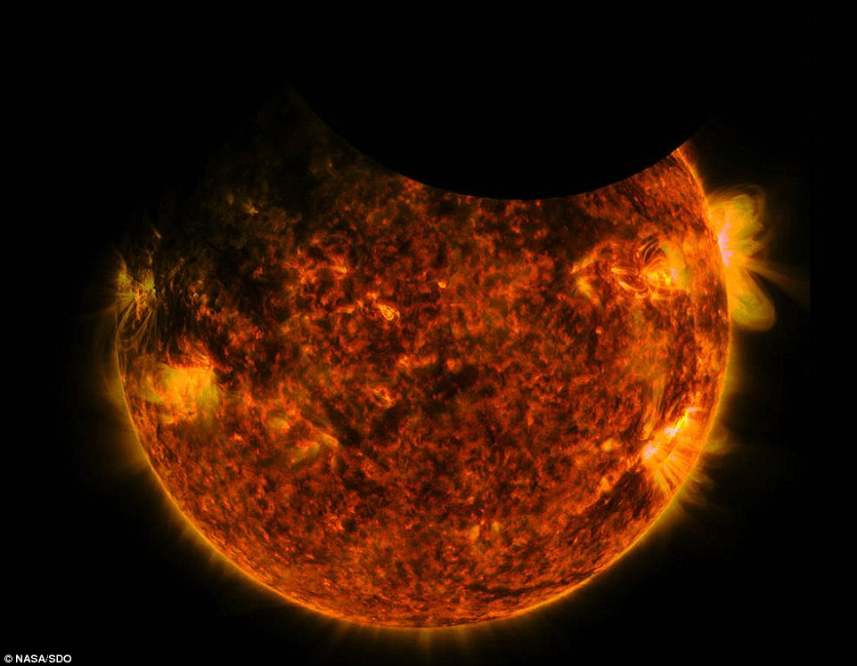 The SDO captured the moments both Earth and the moon crossed in front of the sun briefly blocking its view. In footage of the event Earth can be seen passing across the face of the sun first distinguished by its ¿fuzzy¿ appearance and ending just