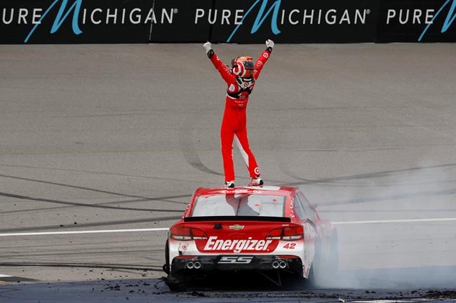 Kyle Larson celebrates winning the NASCAR Sprint Cup Series auto race at Michigan International Speedway in Brooklyn Mich. Sunday Aug. 28 2016